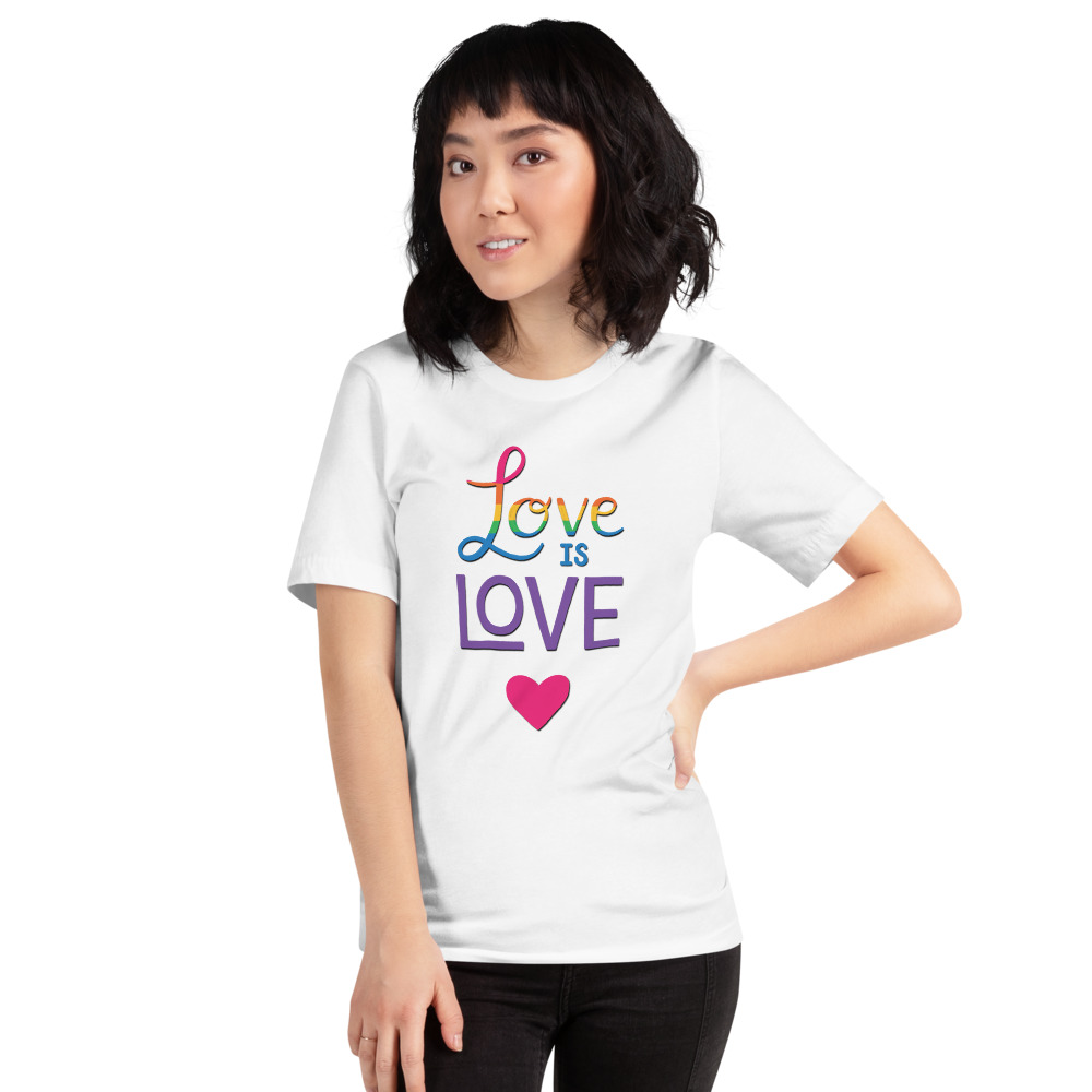 woman wearing a love is love white t-shirt with a pink heart